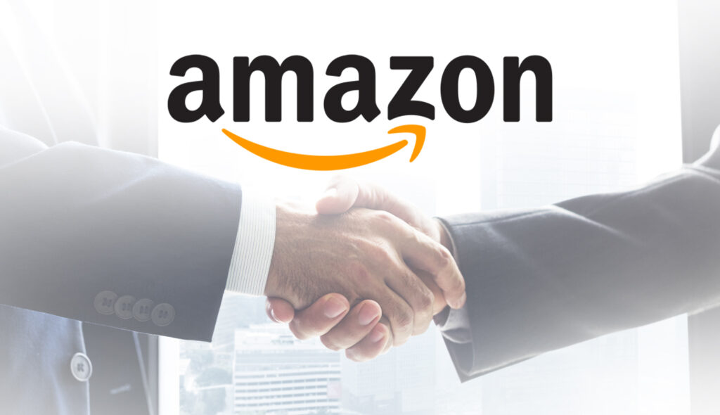 Two People Shaking Hands With The Amazon Logo Behind