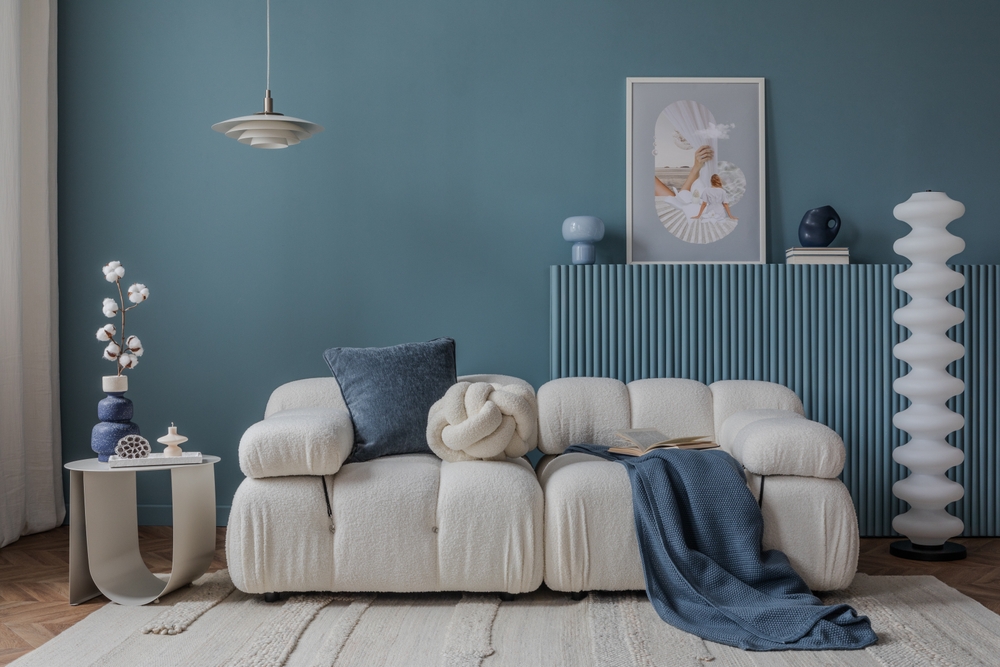 Minimalist,interior,with,a,boucle,sofa,,blue,accents,,and,artistic