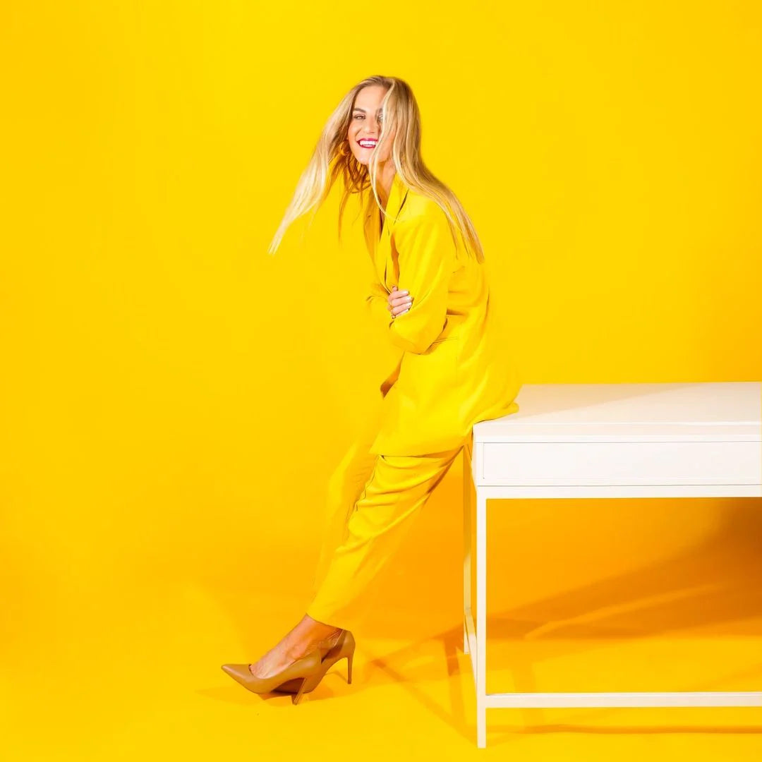 Pink Stork founder Amy Suzanne in a yellow studio setting
